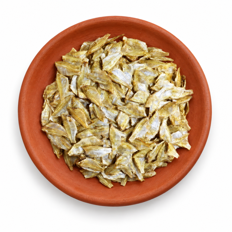 Dried False White Sardine (Headless) on a Kerala clay plate against white